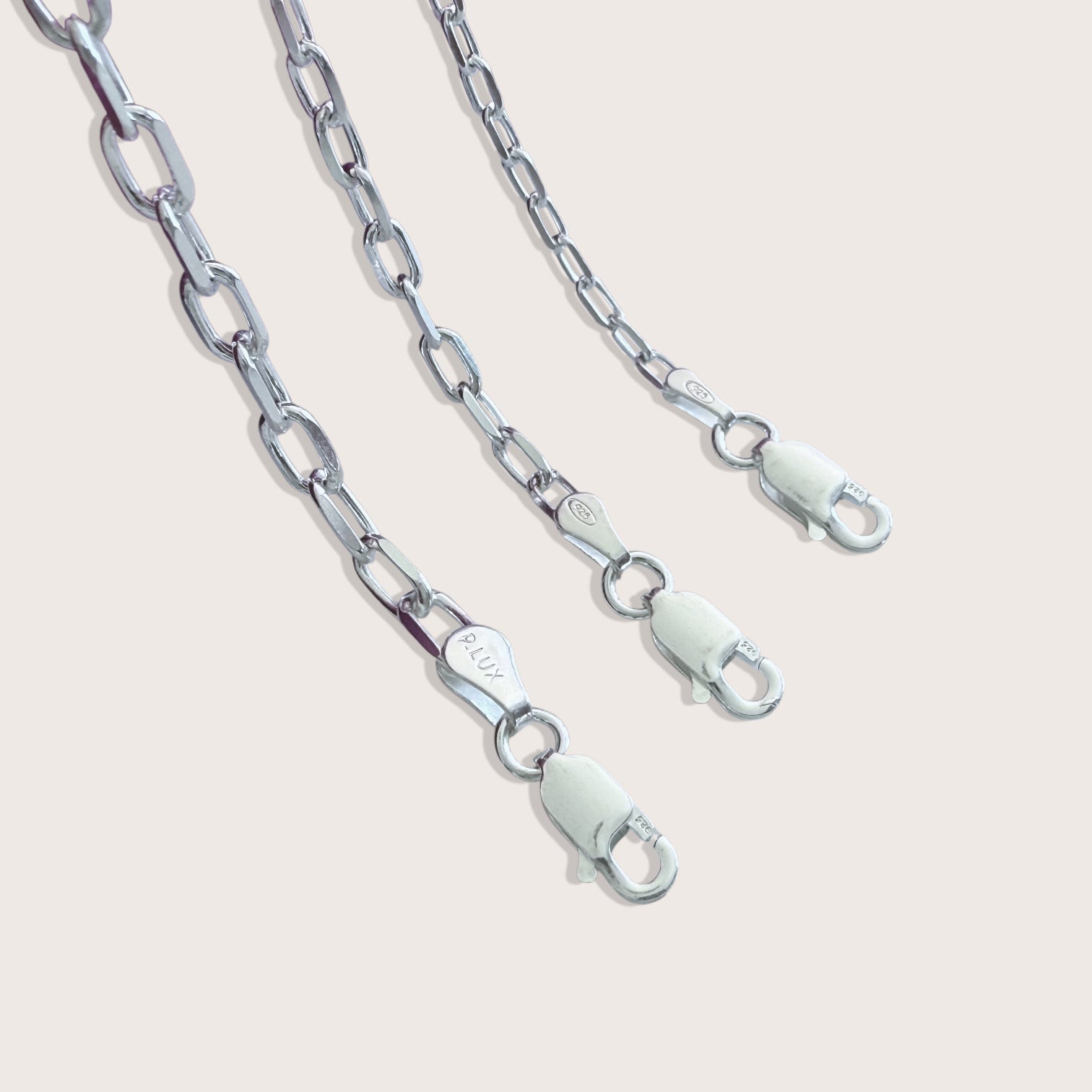 Close up view of the heavy duty Italian lobster claw clasp on a solid 925 sterling silver mariner chain bracelet by Ashley Nicole Jewelry.