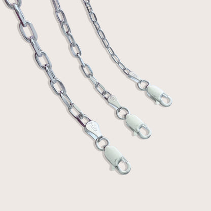 Close up view of the heavy duty Italian lobster claw clasp on a solid 925 sterling silver mariner chain bracelet by Ashley Nicole Jewelry.