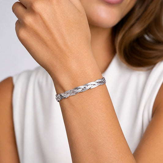 Sterling silver braided herringbone bracelet shown close-up on a wrist