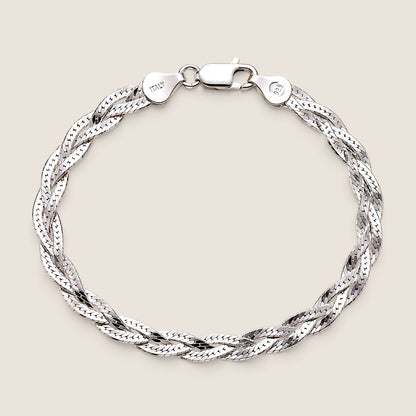 Overhead view of a sterling silver braided herringbone bracelet with lobster clasp