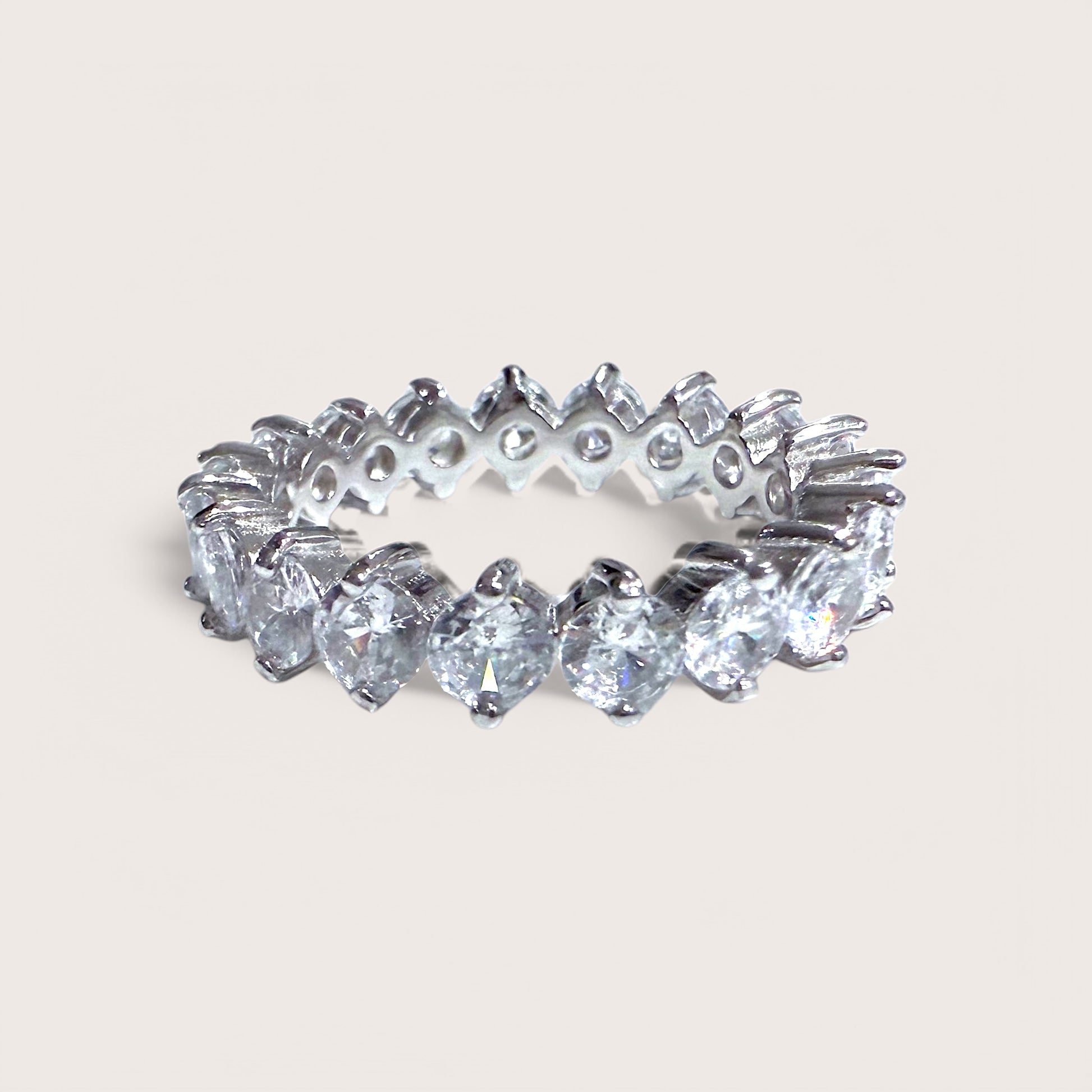 A sterling silver eternity band ring with round cut cubic zirconia stones throughout.