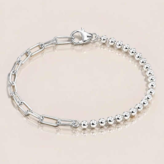 Sterling silver half-bead, half-paperclip bracelet with a lobster clasp on a warm neutral background