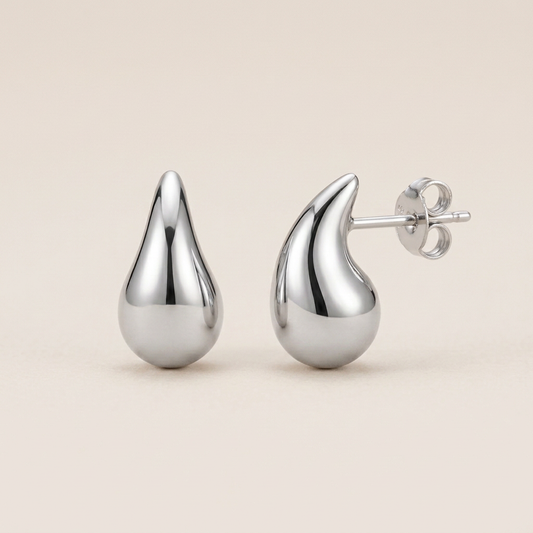 Mirror-polished sterling silver teardrop studs shown upright from the front and side
