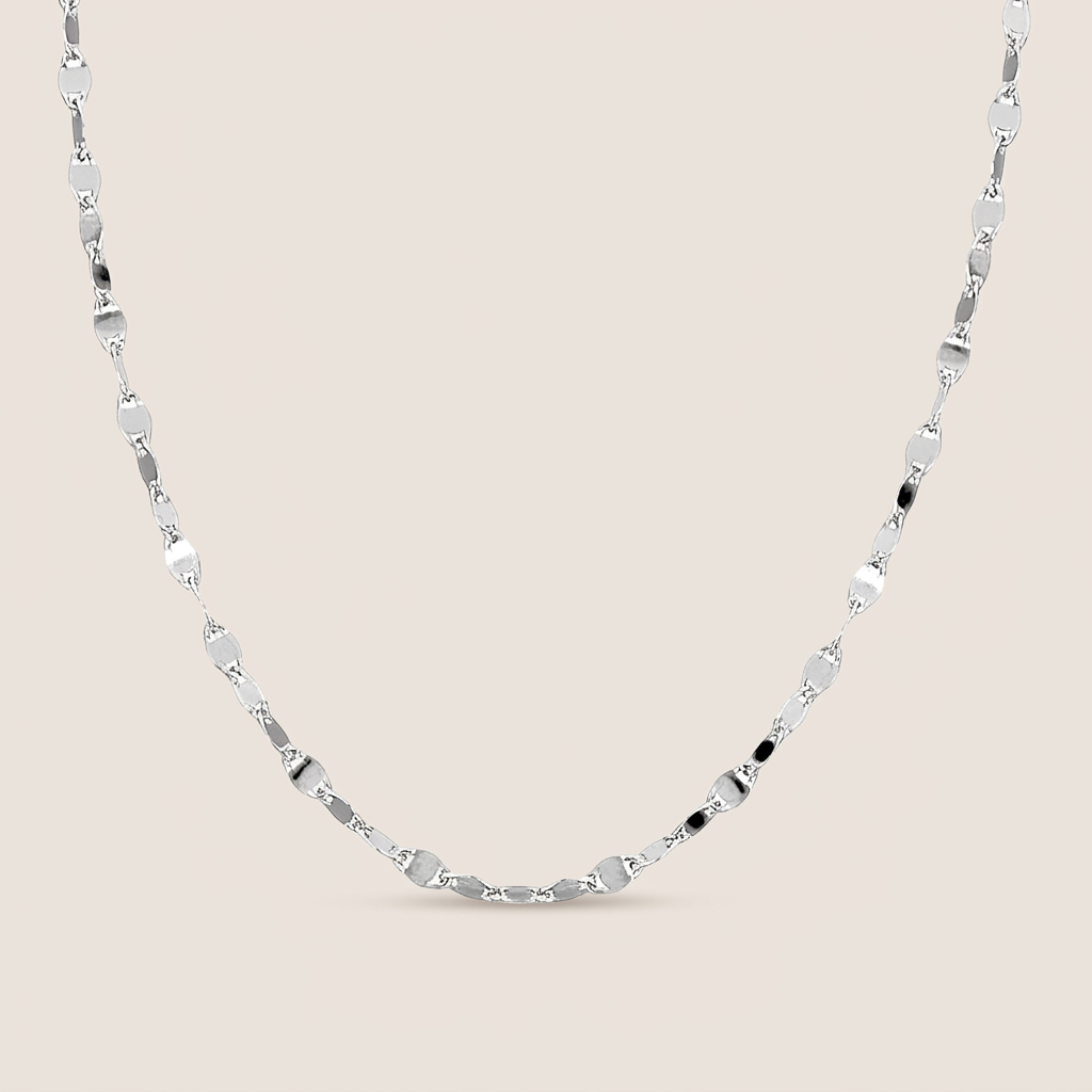 Sterling silver Valentino mirror link necklace arranged in a U shape on a warm neutral background