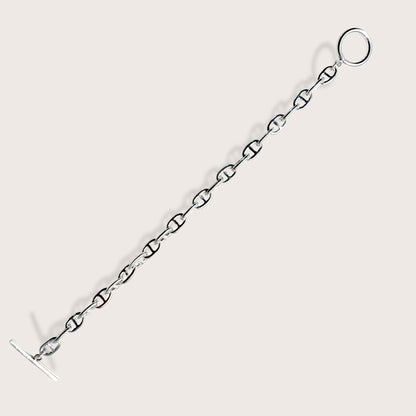 Side-angle view showing the weight and high-polish mirror shine of a silver anchor link bracelet