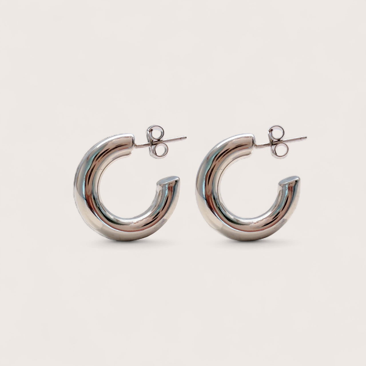 Side view of a pair of thick 925 sterling silver open hoop earrings with secure push back posts.