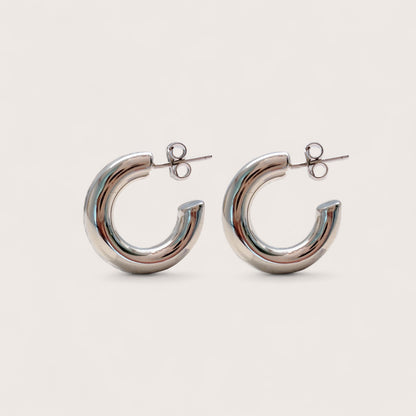 Side view of a pair of thick 925 sterling silver open hoop earrings with secure push back posts.
