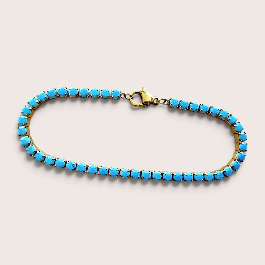 Waterproof gold jewelry stack featuring the dainty turquoise teal gemstone tennis bracelet