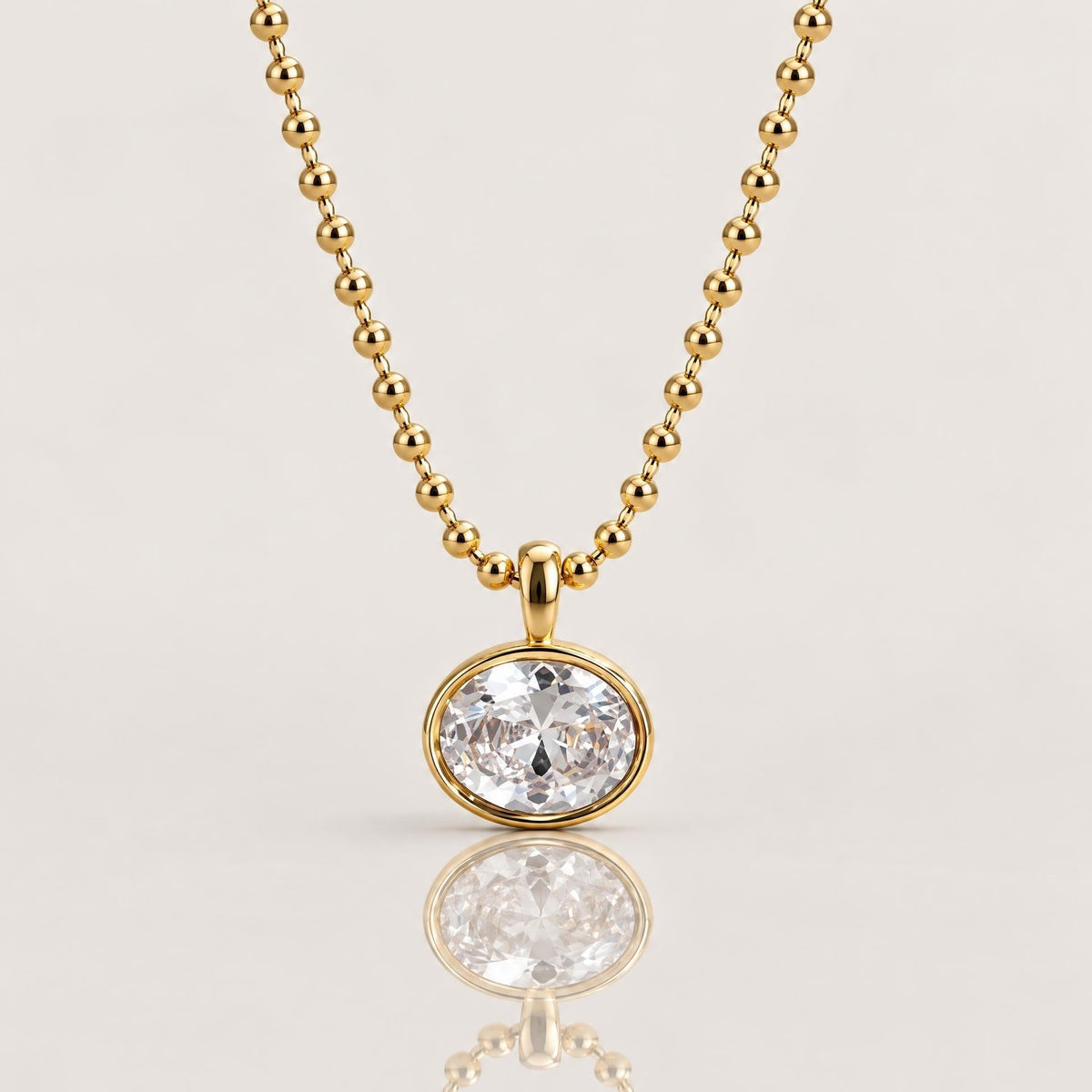18K gold PVD stainless steel horizontal oval bezel-set cubic zirconia pendant necklace on a 2mm beaded ball chain by Ashley Nicole Jewelry