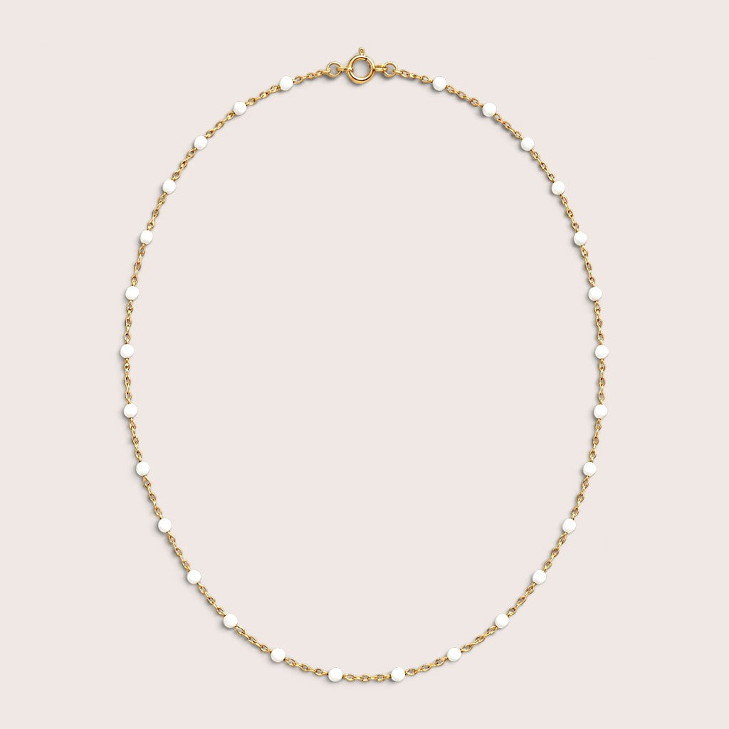 White enamel station beads spaced along a delicate gold-filled necklace