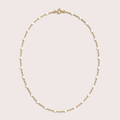 White enamel station beads spaced along a delicate gold-filled necklace